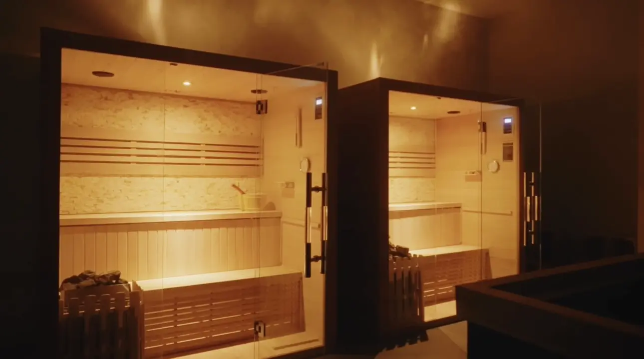 Inviting steam rooms with warm lighting.